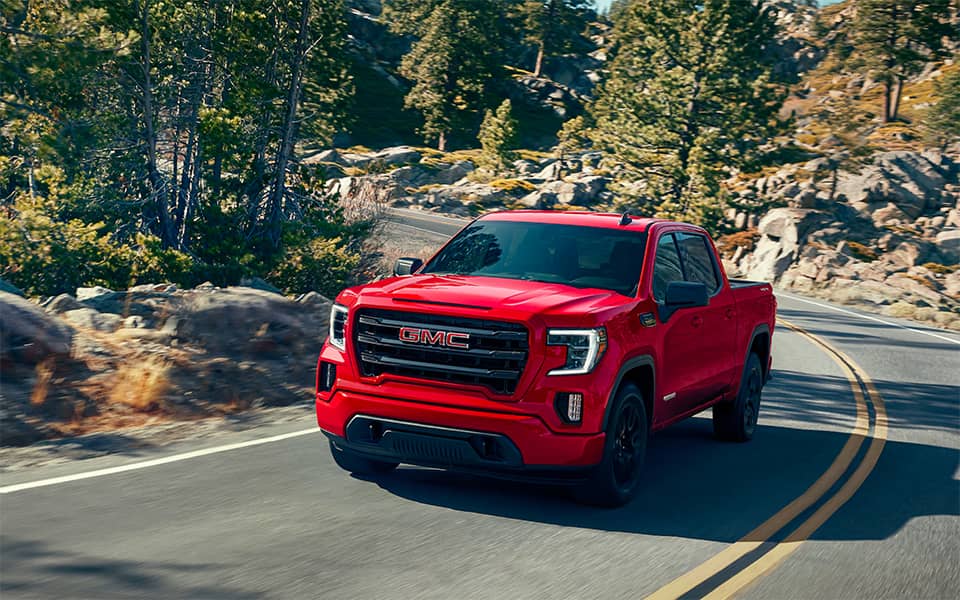 Cardinal Red Sierra 1500 turning on a mountainside